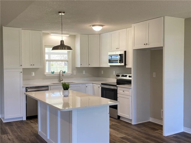 kitchen featuring stainless steel appliances, a sink, light countertops, and white cabinets