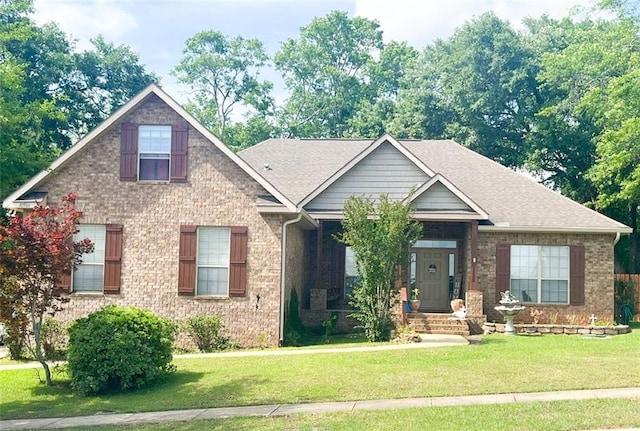 craftsman-style home with brick siding and a front yard
