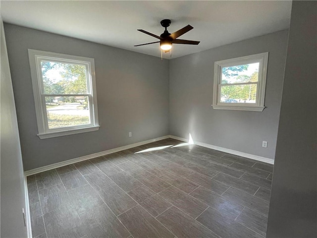 spare room featuring plenty of natural light and ceiling fan