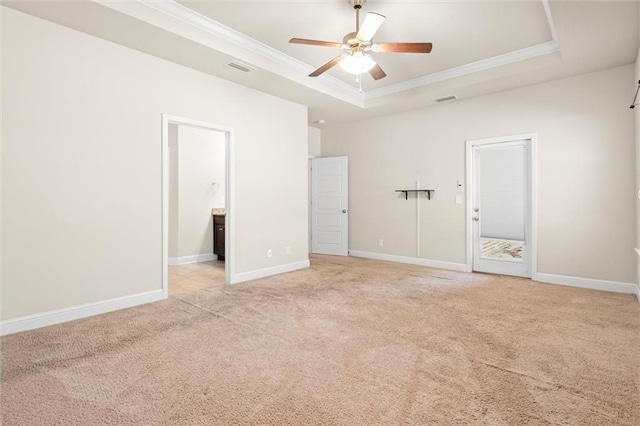 unfurnished bedroom featuring connected bathroom, a raised ceiling, ceiling fan, and crown molding