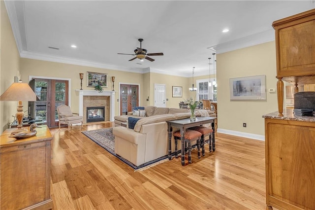 6400 Harbor Place Dr, Daphne, AL 36526 - living room featuring a glass covered fireplace, baseboards, a ceiling fan, and light wood finished floors