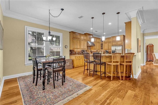 6400 Harbor Place Dr, Daphne, AL 36526 - dining space featuring baseboards, ornamental molding, and light wood-style flooring