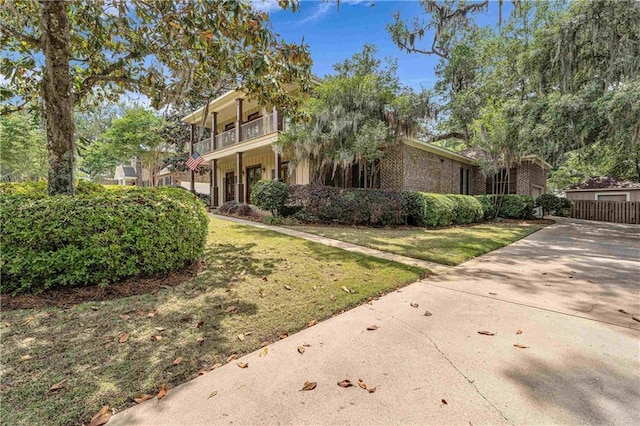 6400 Harbor Place Dr, Daphne, AL 36526 - view of home's exterior with a yard, concrete driveway, and a balcony