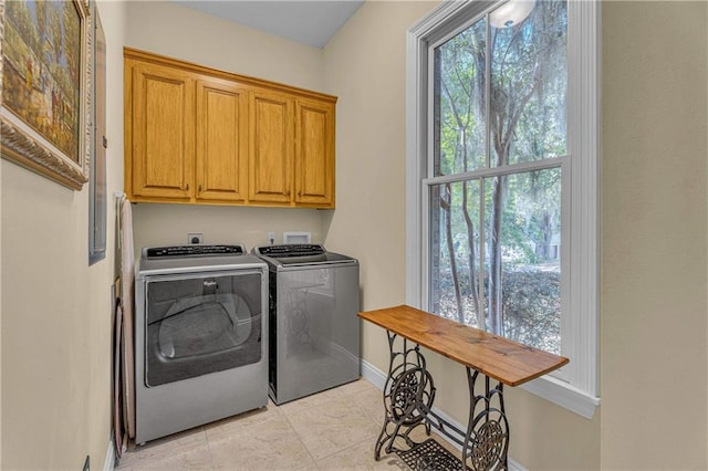 6400 Harbor Place Dr, Daphne, AL 36526 - clothes washing area with cabinet space, separate washer and dryer, baseboards, and light tile patterned floors