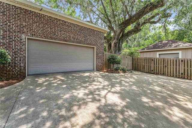 6400 Harbor Place Dr, Daphne, AL 36526 - garage featuring fence and driveway