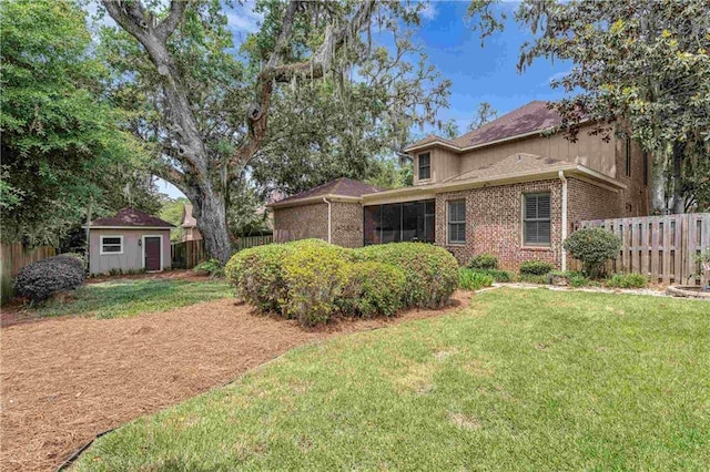 6400 Harbor Place Dr, Daphne, AL 36526 - exterior space featuring brick siding, a fenced backyard, a yard, and an outbuilding