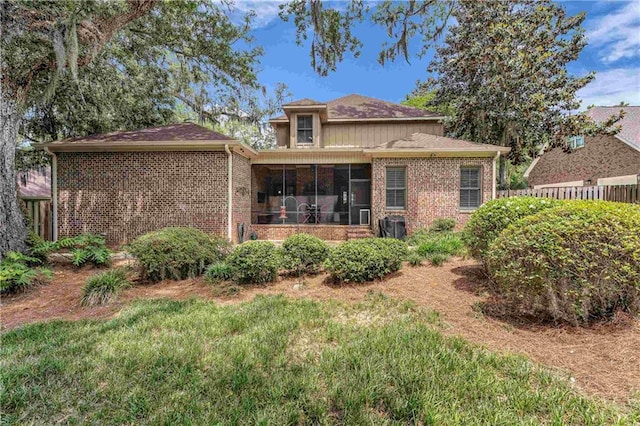 6400 Harbor Place Dr, Daphne, AL 36526 - rear view of property with brick siding, fence, and a sunroom