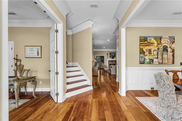 6400 Harbor Place Dr, Daphne, AL 36526 - foyer featuring a fireplace, wood finished floors, visible vents, ornamental molding, and stairway