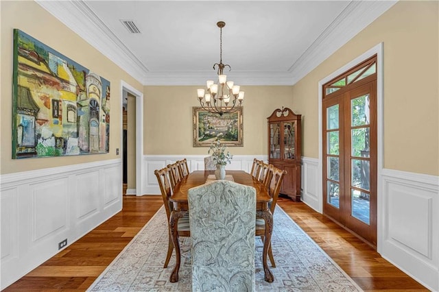 6400 Harbor Place Dr, Daphne, AL 36526 - dining space with visible vents, ornamental molding, wood finished floors, a chandelier, and french doors
