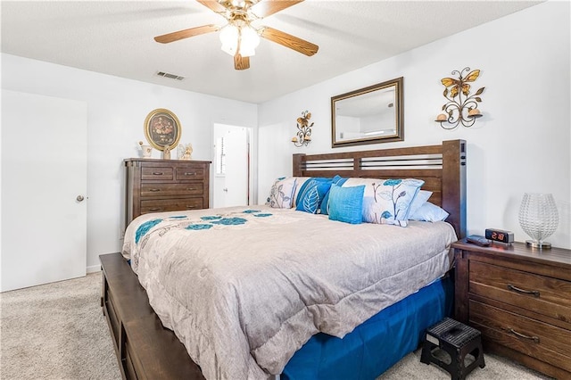 bedroom featuring light colored carpet and ceiling fan