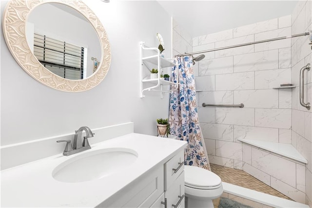 bathroom with walk in shower, vanity, and toilet