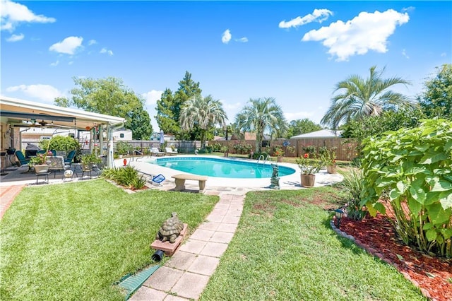 view of pool with a lawn and a patio