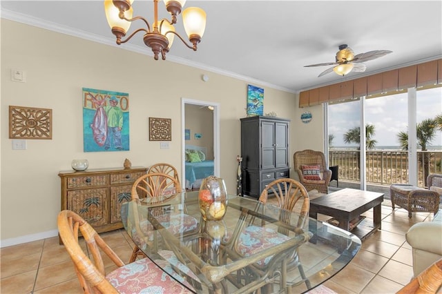 1801 Bienville Blvd Unit 213, Dauphin Island, AL 36528 - dining room featuring light tile patterned flooring, a chandelier, ornamental molding, ceiling fan, and baseboards