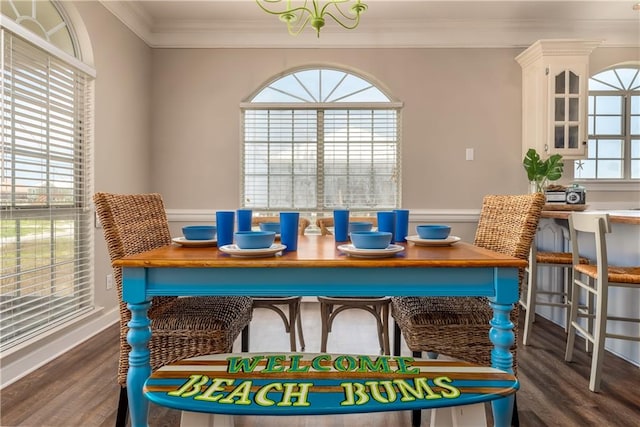 dining area with dark hardwood / wood-style flooring and crown molding