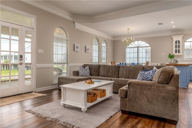 living room with a chandelier, crown molding, and dark hardwood / wood-style flooring