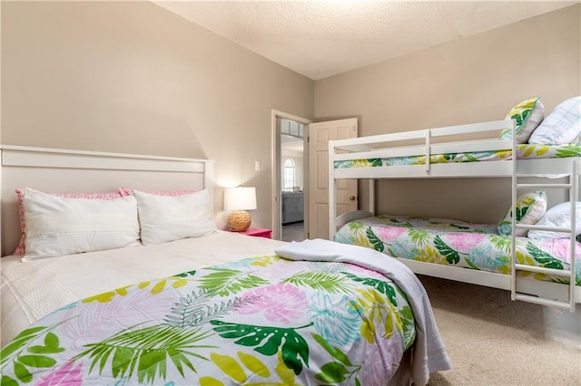 bedroom featuring carpet flooring and a textured ceiling