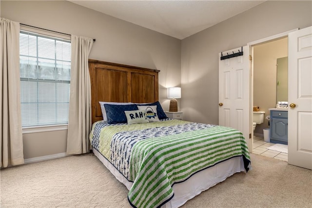 carpeted bedroom with ensuite bathroom