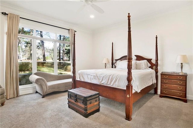 carpeted bedroom featuring crown molding and ceiling fan