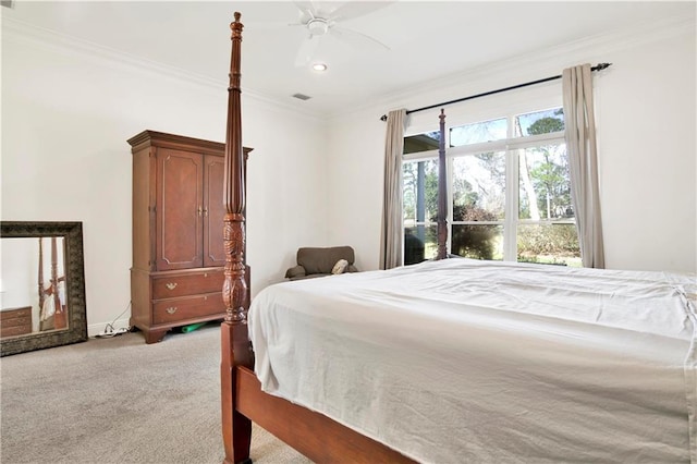 bedroom featuring light carpet, ornamental molding, visible vents, and a ceiling fan