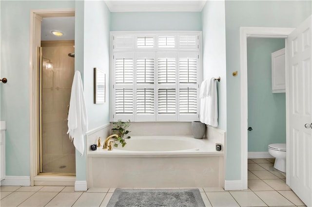 bathroom featuring toilet, a stall shower, a healthy amount of sunlight, tile patterned flooring, and a bath