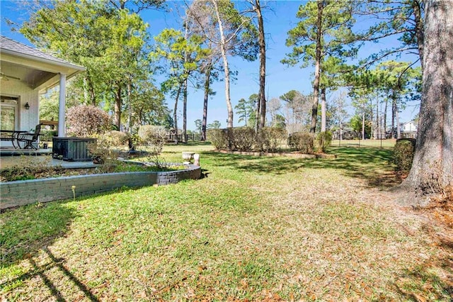 view of yard with cooling unit and fence