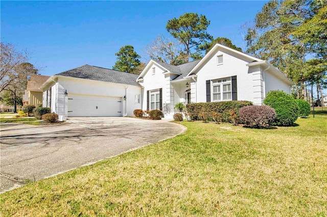 view of front of house with a garage, concrete driveway, and a front lawn