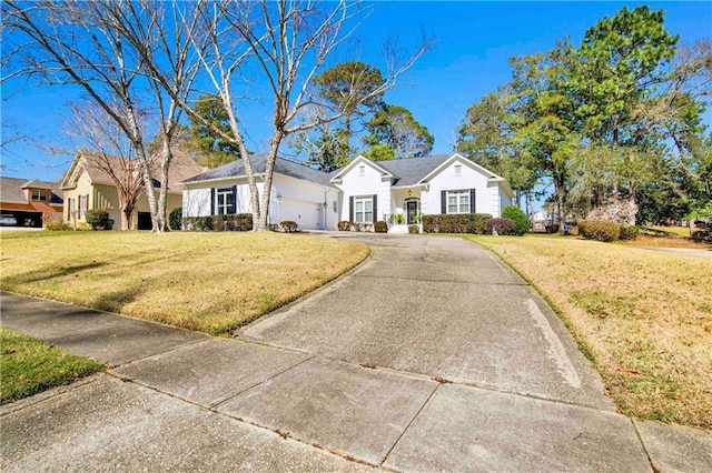 view of front of home with driveway, a front lawn, and an attached garage