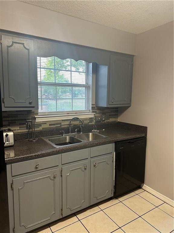 kitchen featuring light tile patterned flooring, dishwasher, backsplash, sink, and gray cabinetry