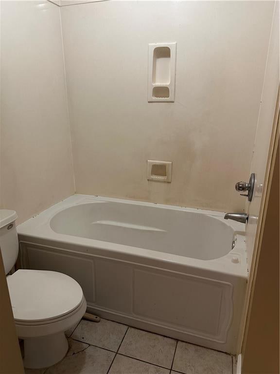 bathroom featuring toilet and tile patterned flooring