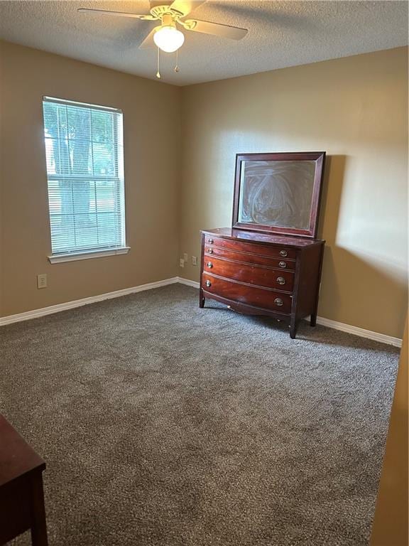 bedroom with carpet flooring, a textured ceiling, and ceiling fan