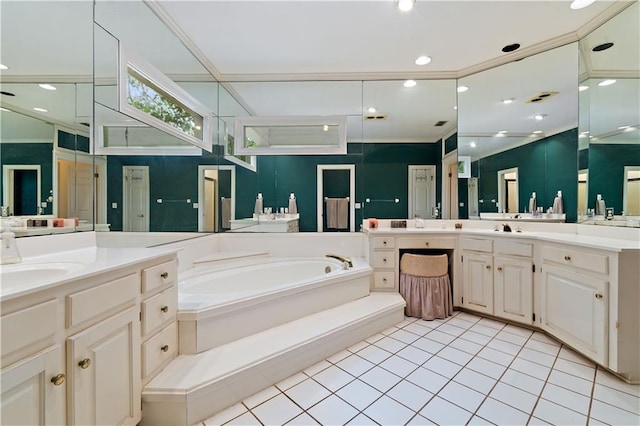 bathroom with tile floors, vanity with extensive cabinet space, and a bath to relax in