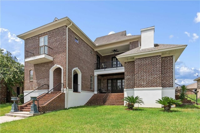 view of front of house featuring a balcony and a front lawn