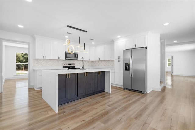 3158 Lees Ln, Mobile, AL 36693 - kitchen with light wood-style flooring, tasteful backsplash, white cabinetry, appliances with stainless steel finishes, and light countertops