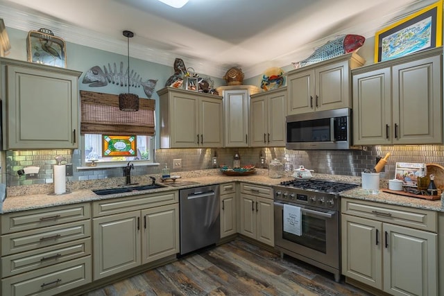 kitchen with light stone countertops, stainless steel appliances, sink, decorative light fixtures, and dark hardwood / wood-style floors