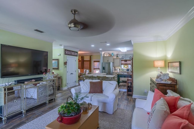 living room with dark hardwood / wood-style flooring, ceiling fan, and crown molding