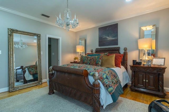 bedroom featuring light hardwood / wood-style floors, a chandelier, and ornamental molding