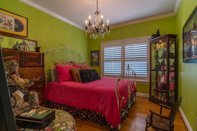 bedroom with a chandelier, hardwood / wood-style floors, and crown molding