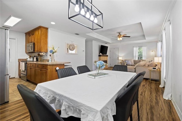 1411 Creola Axis Loop Rd, Axis, AL 36505 - dining room with a ceiling fan, a tray ceiling, dark wood-type flooring, ornamental molding, and recessed lighting