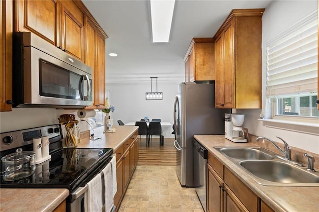 1411 Creola Axis Loop Rd, Axis, AL 36505 - kitchen with stainless steel appliances, a sink, brown cabinetry, light countertops, and recessed lighting