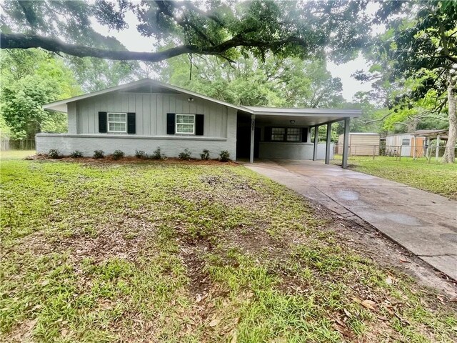 3905 Charmaine Cir E, Mobile, AL 36605 - ranch-style home featuring board and batten siding, driveway, a carport, and brick siding