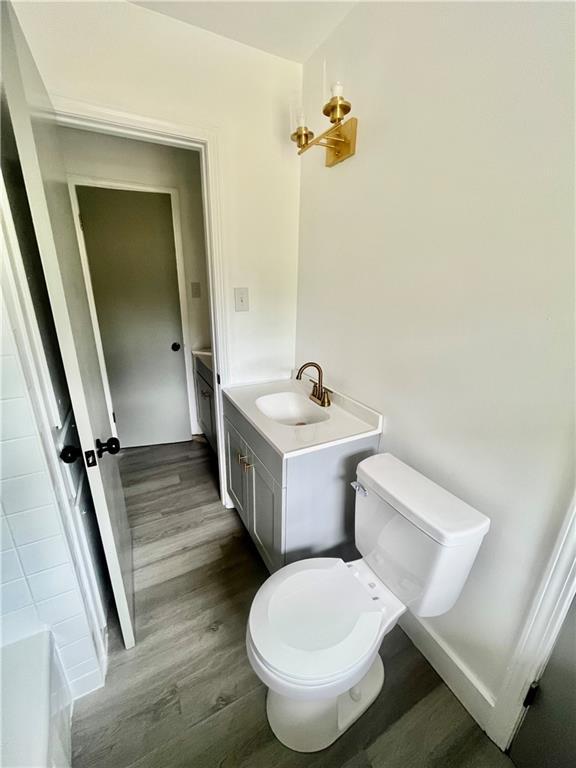 3905 Charmaine Cir E, Mobile, AL 36605 - bathroom featuring wood finished floors, toilet, and vanity