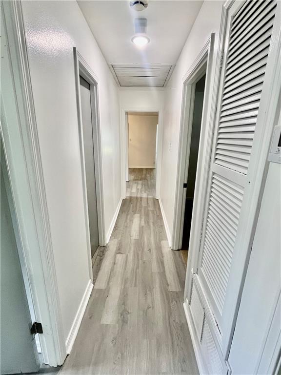 3905 Charmaine Cir E, Mobile, AL 36605 - corridor featuring light wood-style floors and baseboards