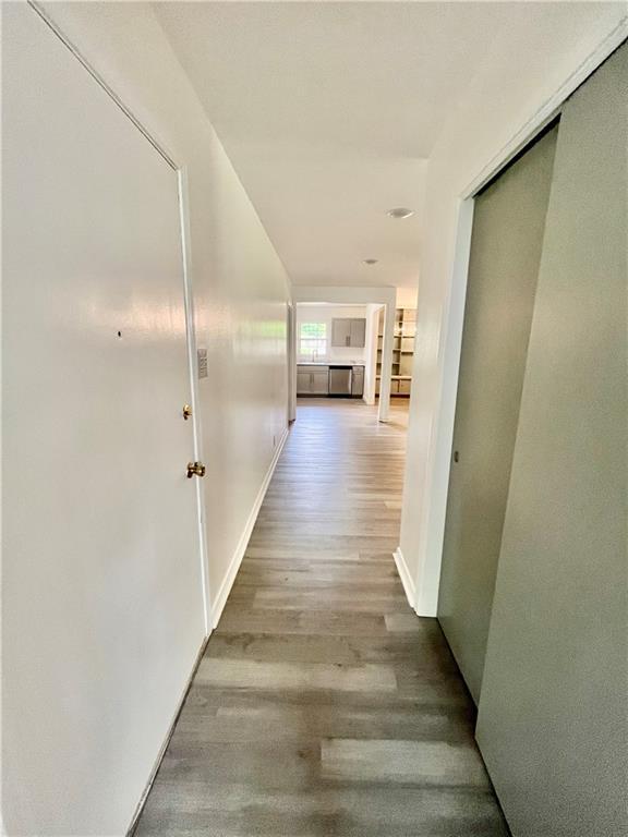 3905 Charmaine Cir E, Mobile, AL 36605 - hallway with wood finished floors and baseboards