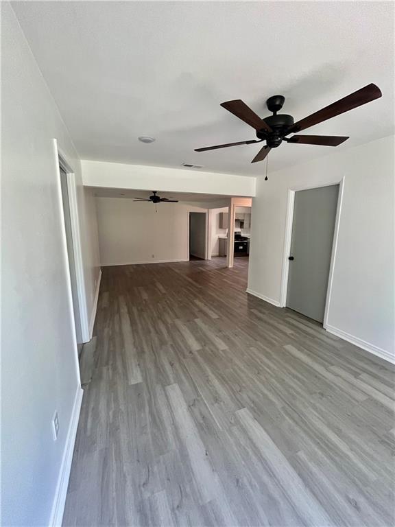 3905 Charmaine Cir E, Mobile, AL 36605 - unfurnished living room with a ceiling fan, baseboards, and wood finished floors