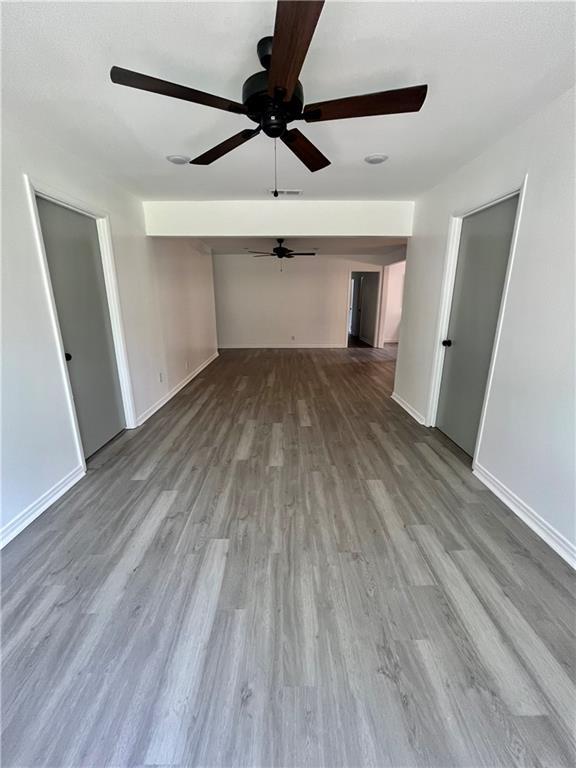 3905 Charmaine Cir E, Mobile, AL 36605 - spare room featuring a ceiling fan, wood finished floors, and baseboards