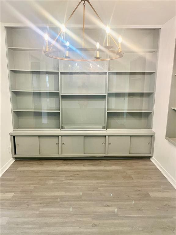 3905 Charmaine Cir E, Mobile, AL 36605 - unfurnished dining area featuring a chandelier, baseboards, and wood finished floors