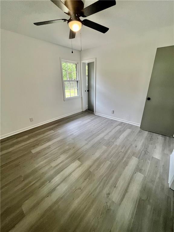 3905 Charmaine Cir E, Mobile, AL 36605 - unfurnished bedroom featuring wood finished floors, baseboards, and a ceiling fan