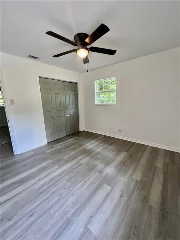 3905 Charmaine Cir E, Mobile, AL 36605 - unfurnished bedroom with a closet, wood finished floors, baseboards, and ceiling fan