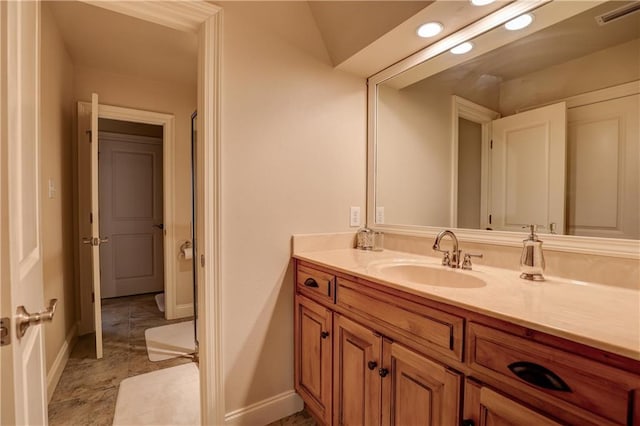 bathroom with vanity and lofted ceiling