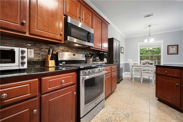 9486 Labrador Run N, Mobile, AL 36695 - kitchen featuring appliances with stainless steel finishes, a chandelier, tasteful backsplash, crown molding, and light tile patterned floors